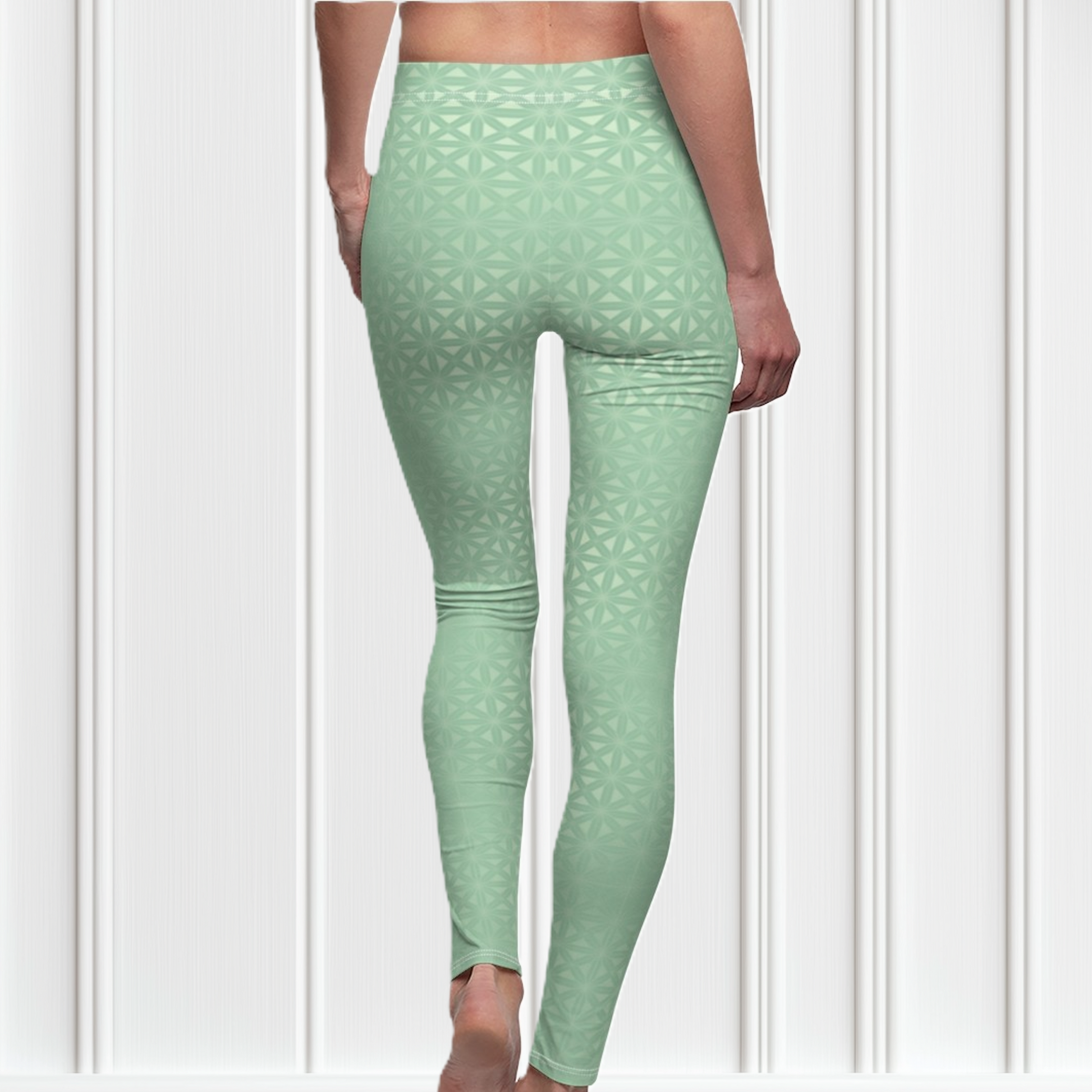 These high waisted women's leggings are a light green with a geometric pattern overlayed overtop, some spots are brighter than others showcasing some spots more than others.