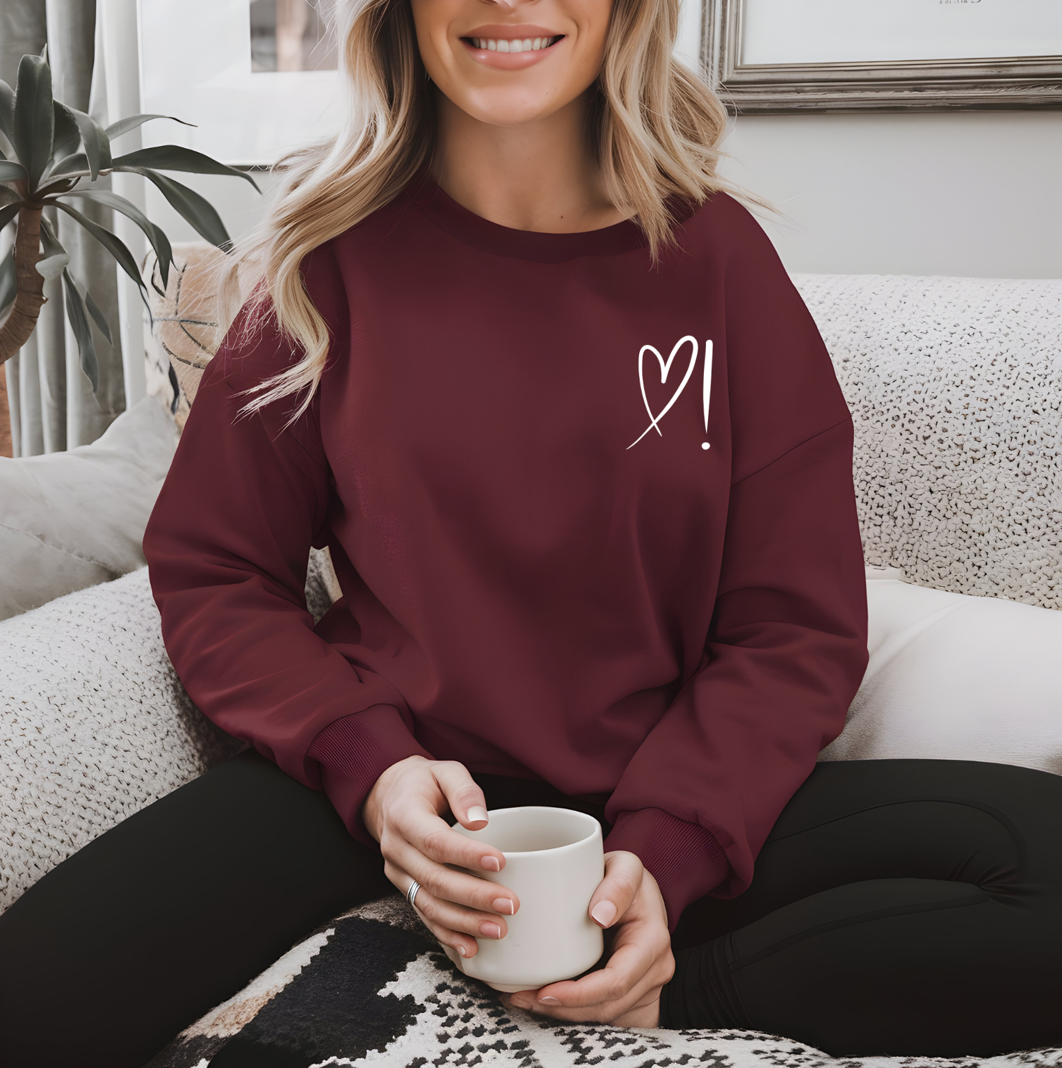 A handmade unisex oversized pullover sweatshirt with a crewneck, on the front left chest of the sweater in white is a heart with an exclamation point on the left hand side if the heart