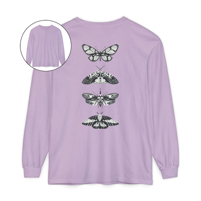 On the back of this long sleeve women's shirt right in between the shoulder blades is a row of black and white butterflies, starting at the top of the back and headed to the bottom of the shirt.