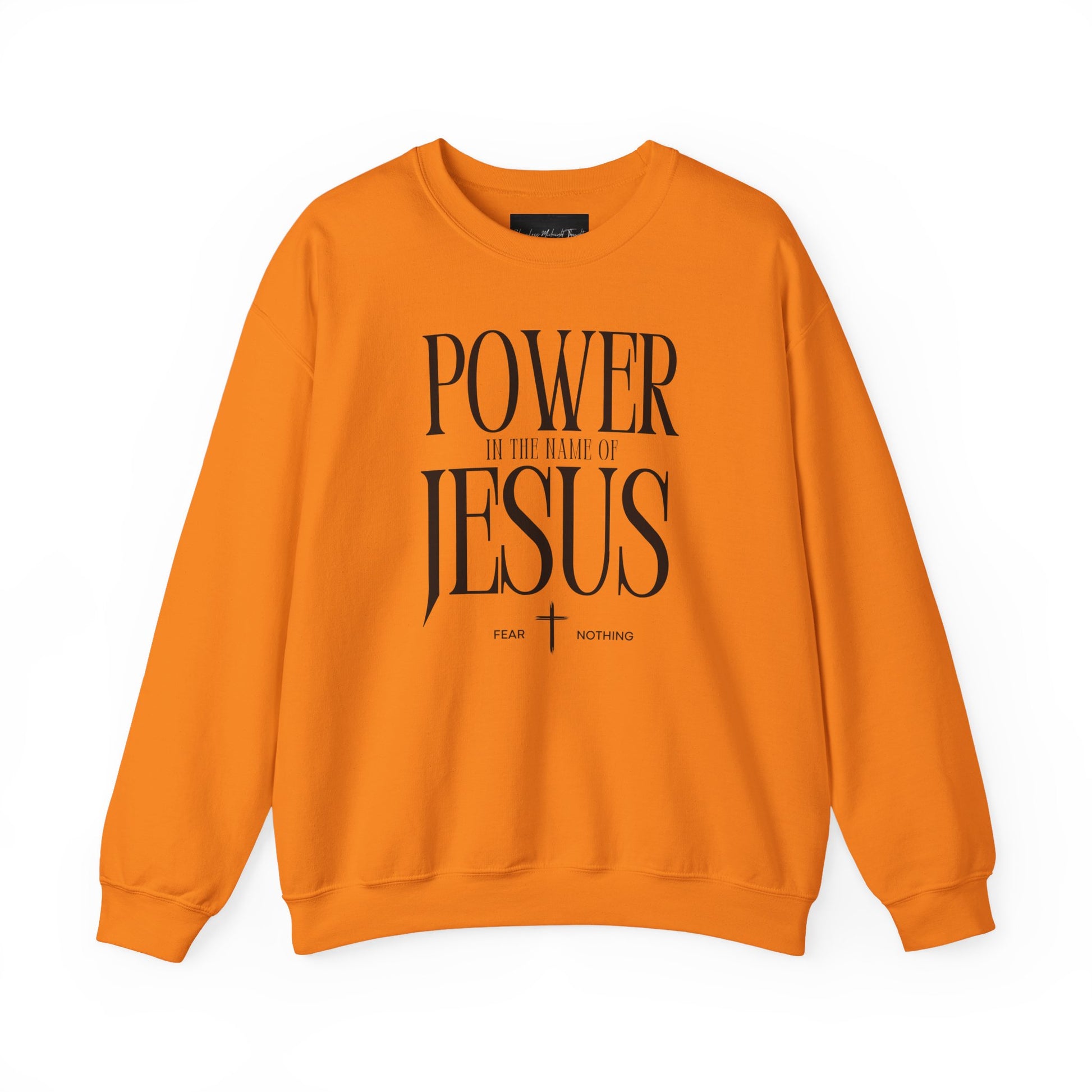 On the front of this Christian pullover sweatshirt it says Power In The Name Of Jesus with a Jesus cross underneath it, on either side of the cross are the words Fear and Nothing.
