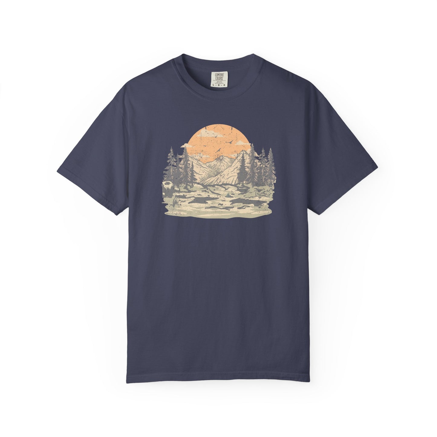 On the front of this custom comfort colors short sleeve t-shirt is a large vintage image of a large valley that opens up to a mountain range with pine trees , there is a large sun in the background with birds flying all around, this t-shirt is completely vintage.