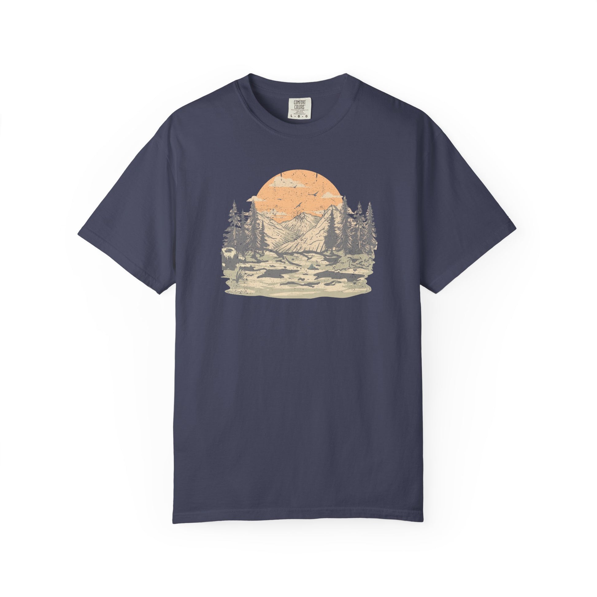 On the front of this custom comfort colors short sleeve t-shirt is a large vintage image of a large valley that opens up to a mountain range with pine trees , there is a large sun in the background with birds flying all around, this t-shirt is completely vintage.