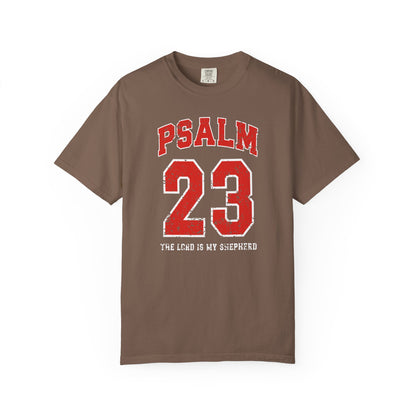 On the front side of this custom vintage t-shirt are the words Psalm 23 The Lord Is My Shepherd, it is with red and white block lettering.