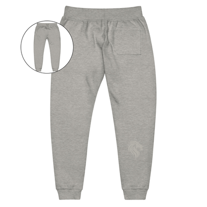 A pair of super soft custom unisex fleece sweatpants with a male lion head on the back calf of the right leg embroidered in silver.
