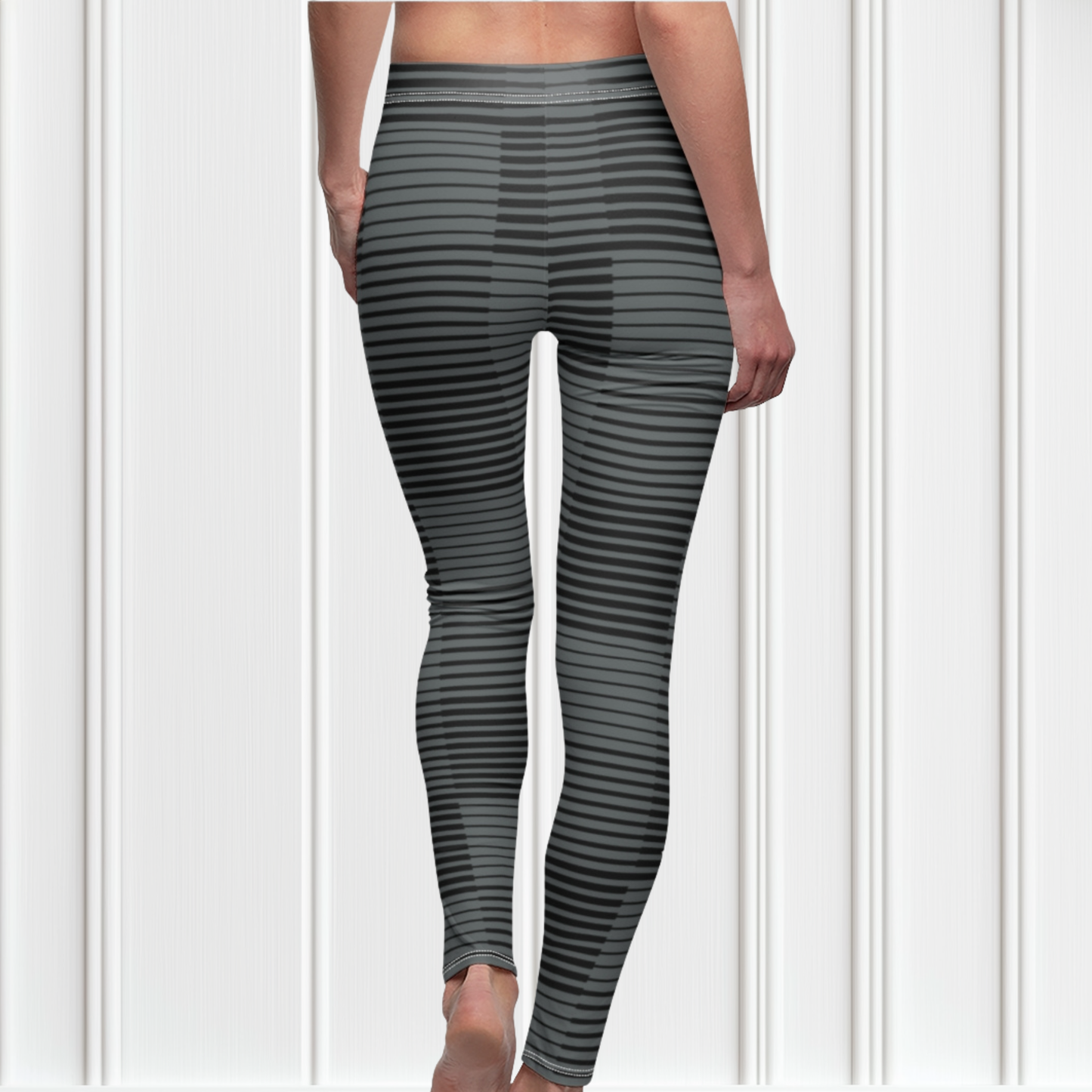 A pair of women's high waisted Christian themed leggings, the pants are light grey  color with black stripes running across the pants, the lines are in different thicknesses from the top to the bottom ankle of the leggings giving it a 3D look when worn, there is a white Jesus cross on the bottom right calf of the pant.