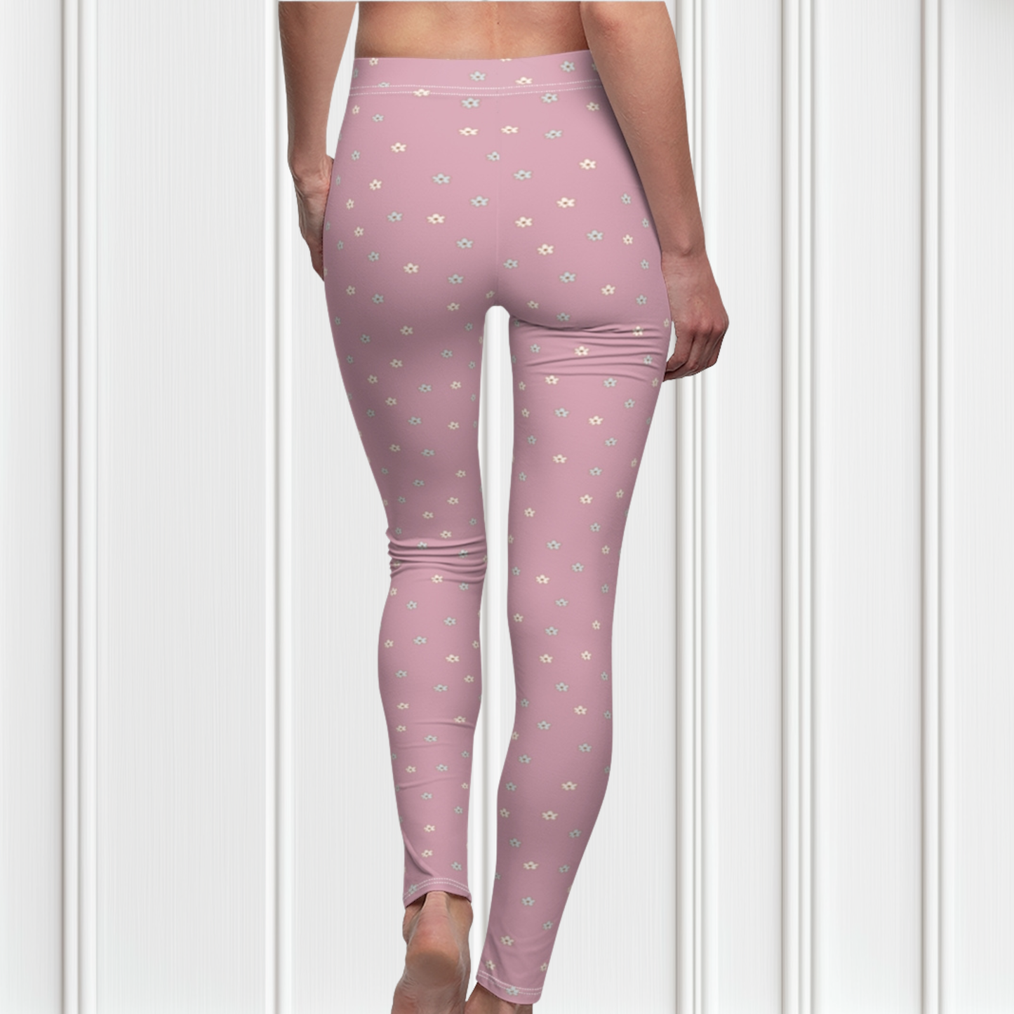 These women's leggings are a dusty rose color with there being little beige flowers all over the entire pair of leggings.