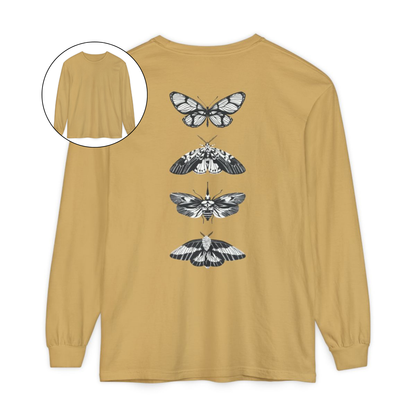 On the back of this long sleeve women's shirt right in between the shoulder blades is a row of black and white butterflies, starting at the top of the back and headed to the bottom of the shirt.