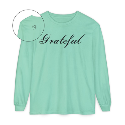 On the front of this custom long sleeve t-shirt in cursive writing is the word grateful on the upper chest, on the back left shoulder blade is an image of a heart with an exclamation mark next to it.
