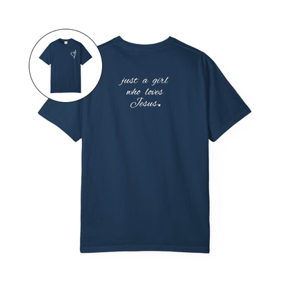 On the front of this custom women's Christian t-shirt is a heart with a cross through it, on the back top of the shirt right between the shoulder blades are the words just a girl who loves Jesus in a cursive writing.