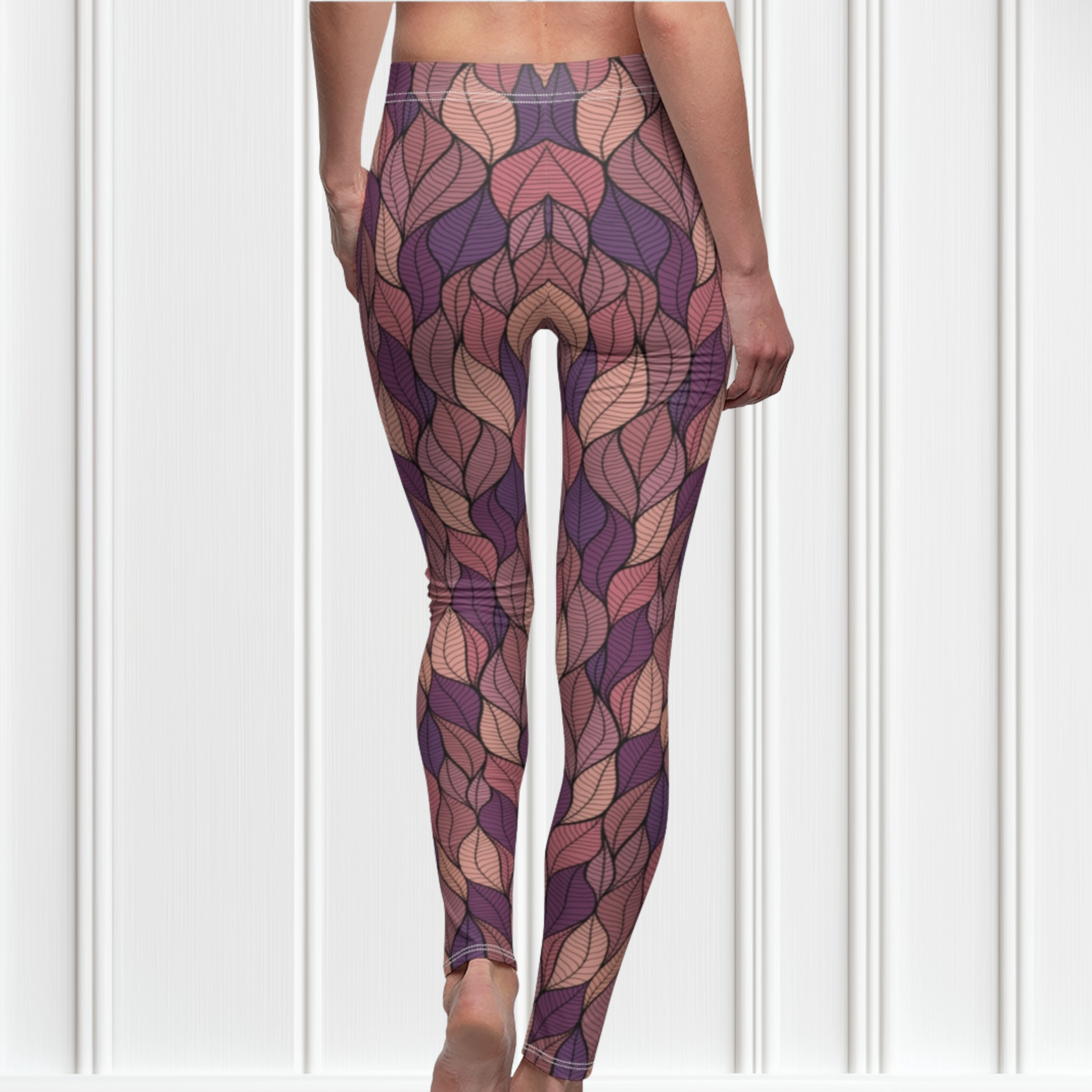 These custom colorful handmade women's leggings have a pattern of multicolored leaves from top to bottom, the leaves are light pink, purple, mauve and beige giving the leggings a vibrant look.