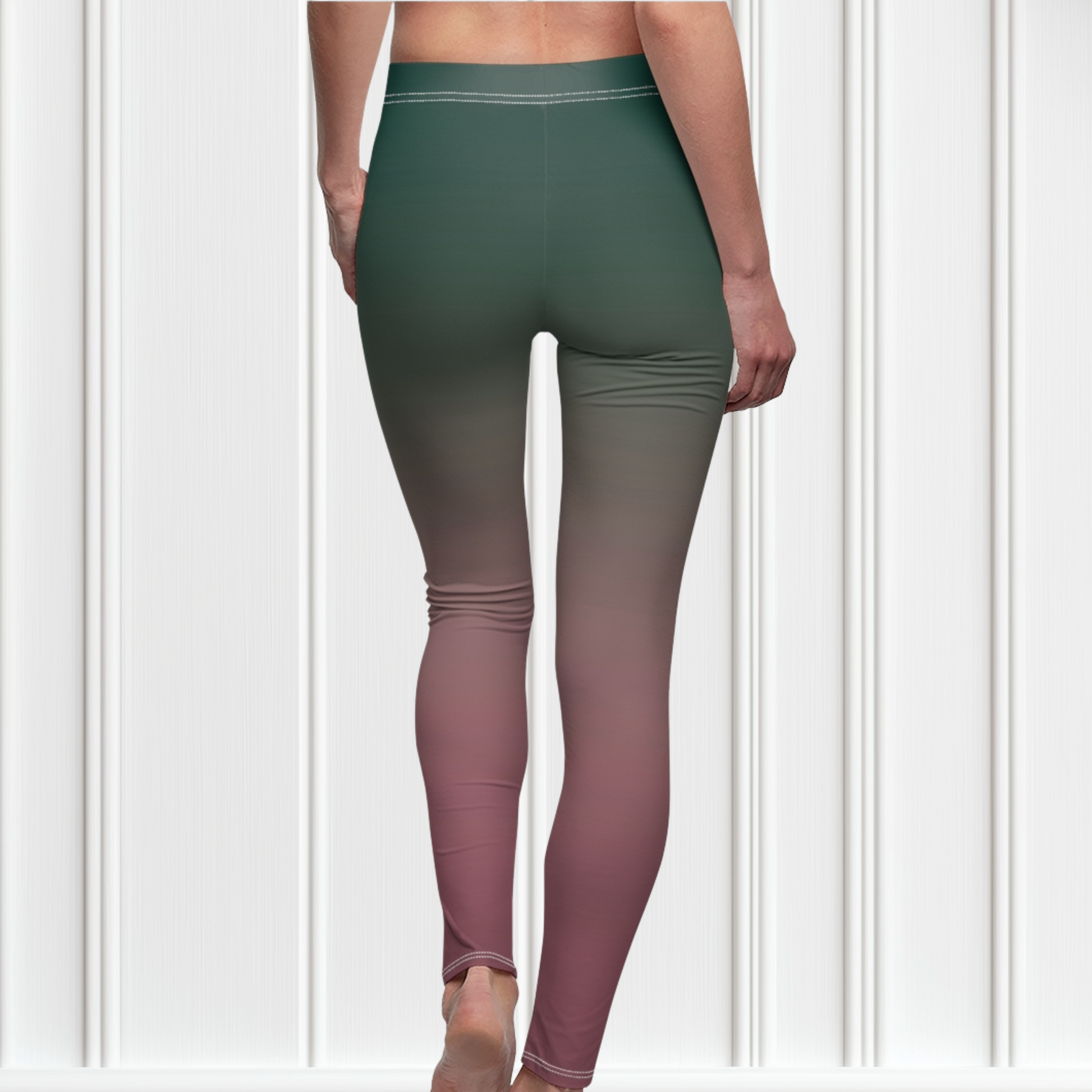 A pair of custom handmade high waisted women's leggings with an ombre pattern that starts as an emerald green at the top then fades to a light purple, then to a deep purple at the ankle of the pant.