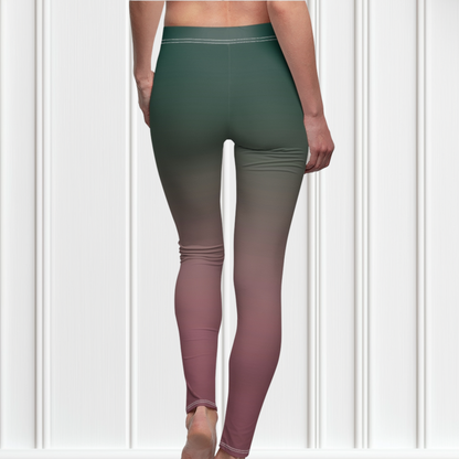 A pair of custom handmade high waisted women's leggings with an ombre pattern that starts as an emerald green at the top then fades to a light purple, then to a deep purple at the ankle of the pant.