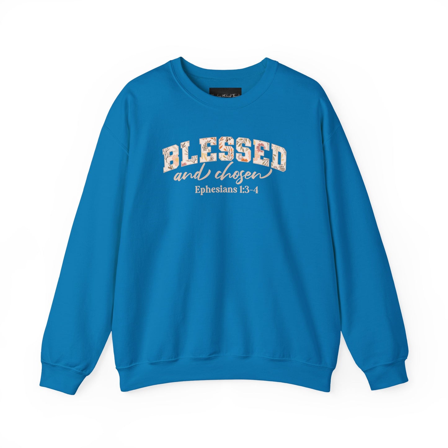 On the front of this custom Christian sweatshirt is the bible verse Blessed and Chosen Ephesians 1:3-4 with the word Blessed being in large bubble letters with a floral pattern on the inside of the letters.