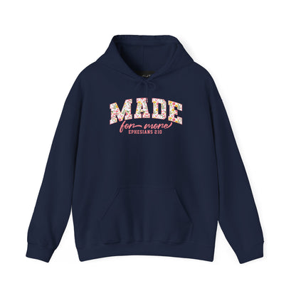 On the front of this custom Christian hoodie is the bible verse the says Made for more Ephesians 2:10, with the word "Made" being large block letters with a pink floral pattern inside the letters, all the other words are in a light pink color.