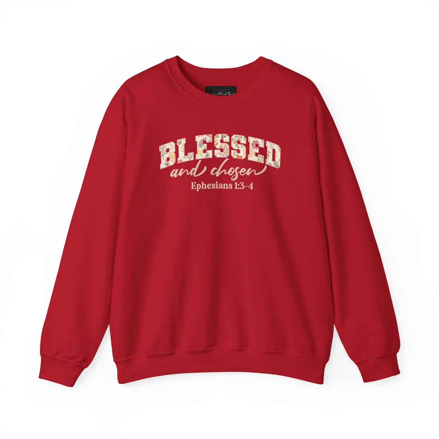 On the front of this custom Christian sweatshirt is the bible verse Blessed and Chosen Ephesians 1:3-4 with the word Blessed being in large bubble letters with a floral pattern on the inside of the letters.