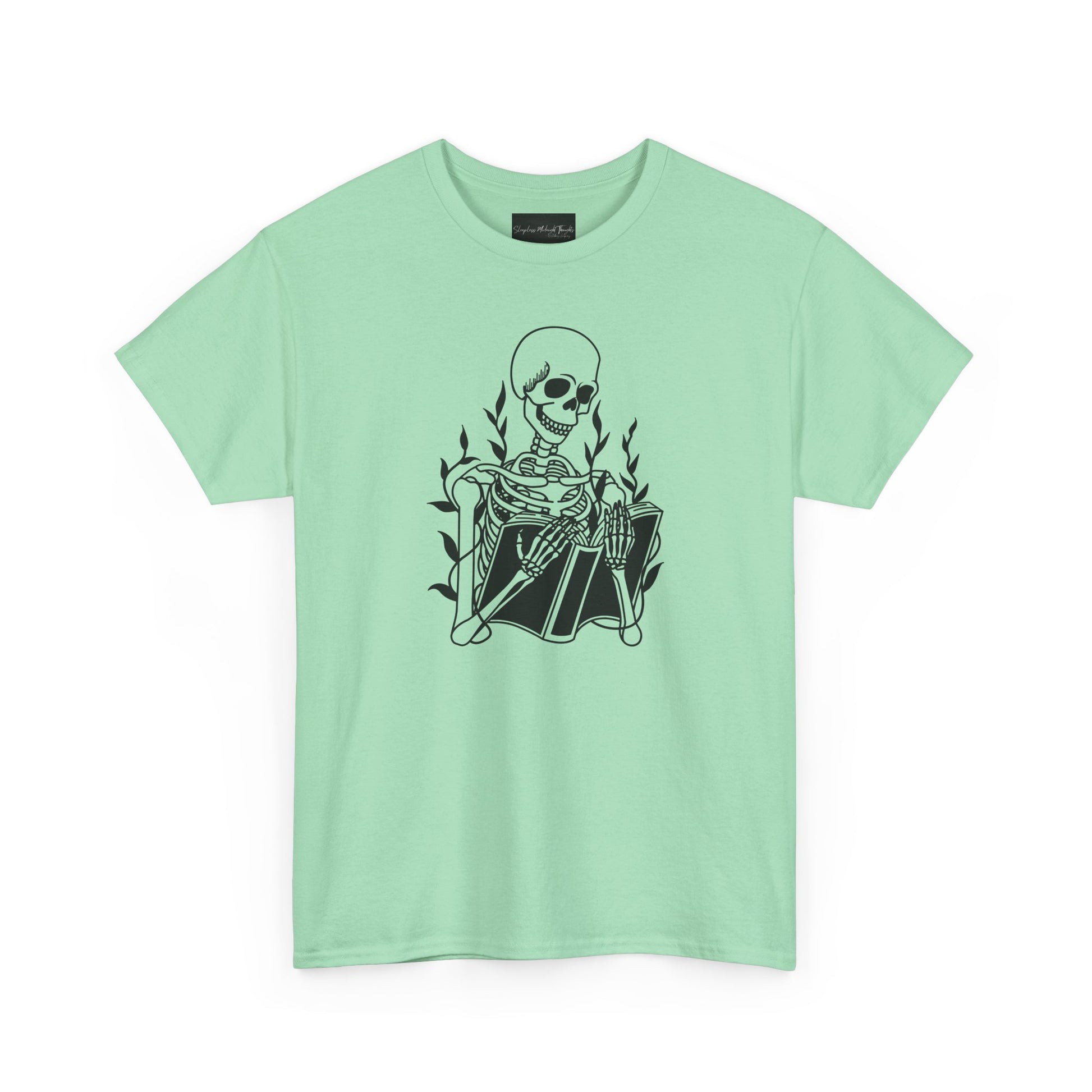 On the front of this custom unisex short sleeve shirt is a large image of a skeleton reading a book, there are vines with leaves on them behind the skeleton.