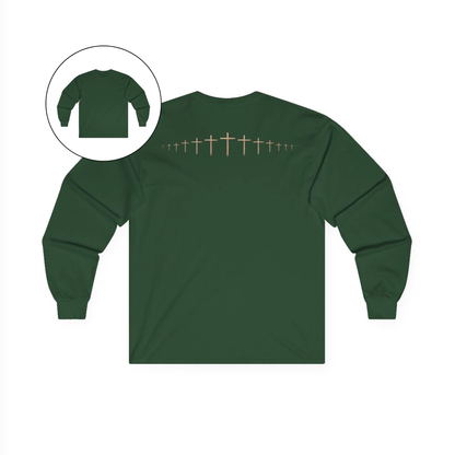 On the back of this forest green colored Christian long sleeve shirt is a large wooden Jesus cross in between the shoulder blades, the Jesus cross then keeps getting smaller and smaller till it fades right off the shirt giving it a amazing 3D look on the back.
