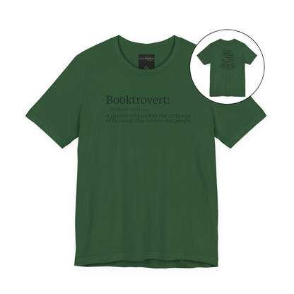 On the front of this custom unisex short sleeve shirt is the word booktrovert with the definition of the word underneath, on the back of the shirt is an image of a large stack of books.