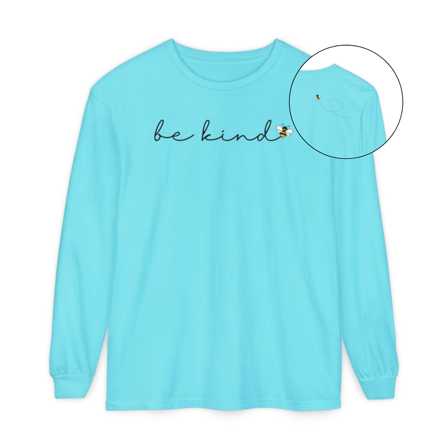 On the front of this custom unisex long sleeve shirt are the words be kind in a simple cursive font, with a bumble bee on the right side of the letter kind, on the back right shoulder there is an image of a bumble bee flying and leaving a trail behind it in the shape of a heart.