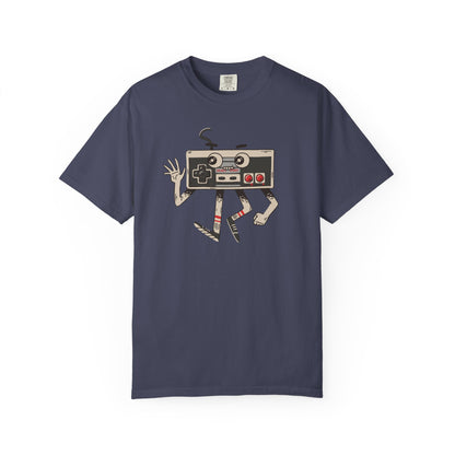 On the front of this custom vintage gaming short sleeve shirt is an image of a old school Nintendo controller, the controller has arms and legs and a face that makes it look like a cartoon character.
