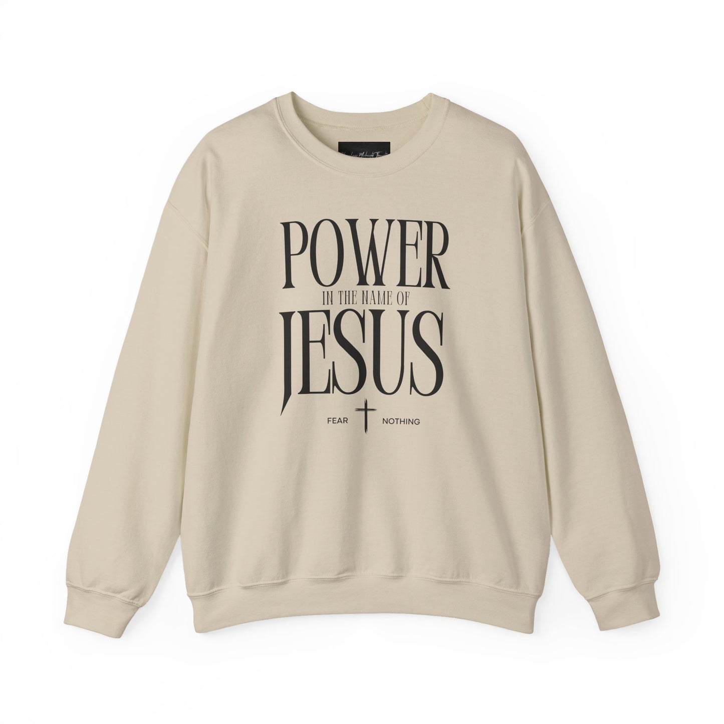 On the front of this Christian pullover sweatshirt it says Power In The Name Of Jesus with a Jesus cross underneath it, on either side of the cross are the words Fear and Nothing.
