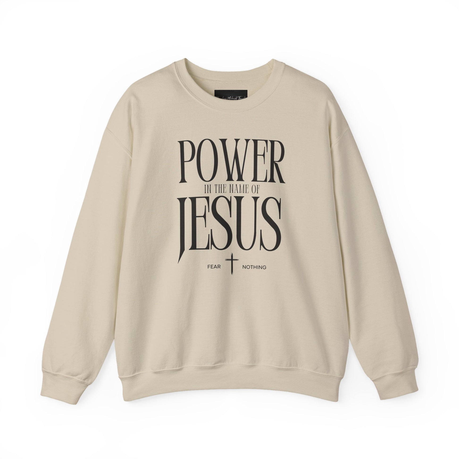 On the front of this Christian pullover sweatshirt it says Power In The Name Of Jesus with a Jesus cross underneath it, on either side of the cross are the words Fear and Nothing.