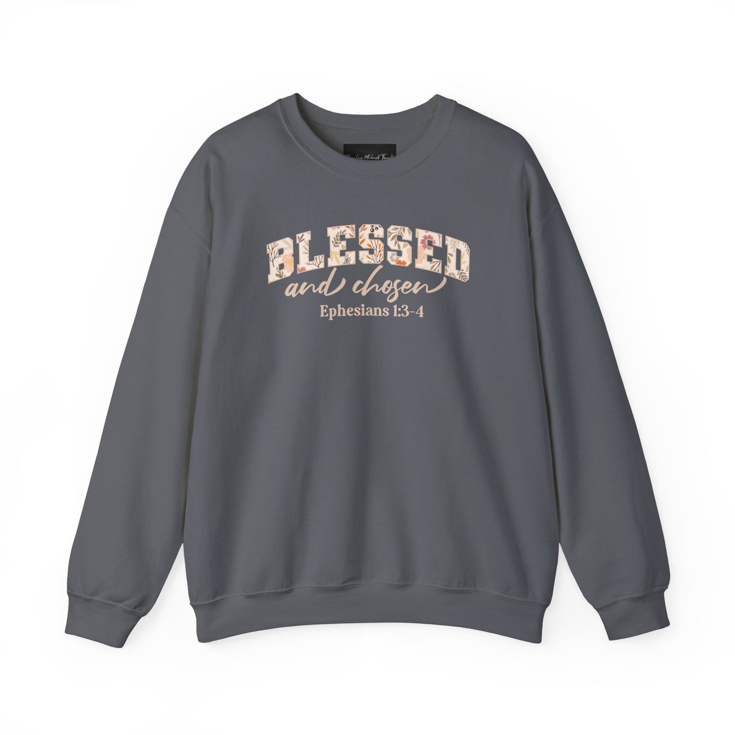 On the front of this custom Christian sweatshirt is the bible verse Blessed and Chosen Ephesians 1:3-4 with the word Blessed being in large bubble letters with a floral pattern on the inside of the letters.