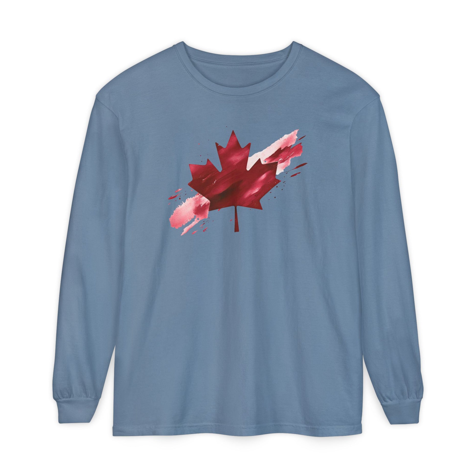 On the front of this unisex long sleeve shirt is an image of a Canadian maple leaf that is bright red, it looks like it has been spray painted onto the front of the shirt.