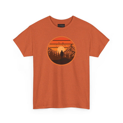 On the front of this custom tee is a large circle on the center of the chest that has an image of bigfoot right in the middle, there is a sun setting with mountain ranges and pine trees in the background.