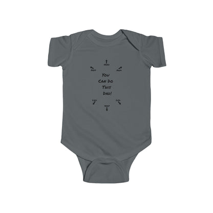 on the front of this custom infant onesie specifically meant for dads, are the words You can do this dad with arrows pointing where each leg and each arm goes along with were the babies head goes and where to close the snaps, a perfect diagram for a new father on how to put a onesie on a baby.