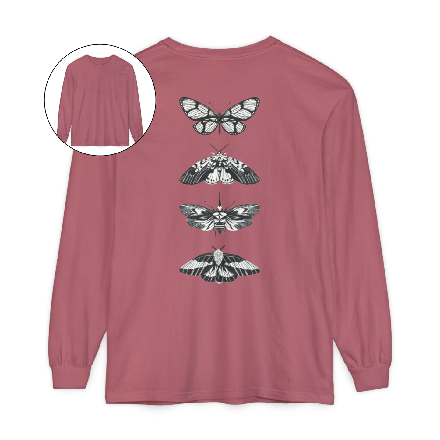 On the back of this long sleeve women's shirt right in between the shoulder blades is a row of black and white butterflies, starting at the top of the back and headed to the bottom of the shirt.