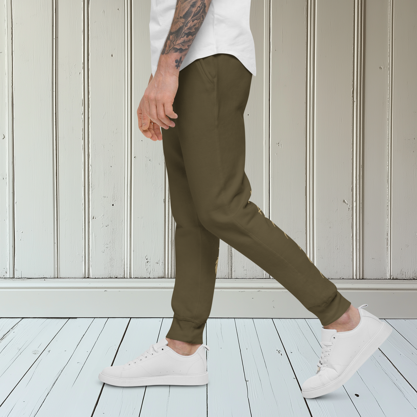 A pair of super soft ankle length unisex sweatpants, there are two pockets on the front and one pocket on the back right, the word warrior is in gold on the back left leg from the knee down and a male lion with a crown on the other