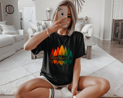 On the front of this custom comfort colors short sleeve shirt is a image of trees in the fall time with all the different fall colors, the trees reflection is right underneath making them look like they are above water.