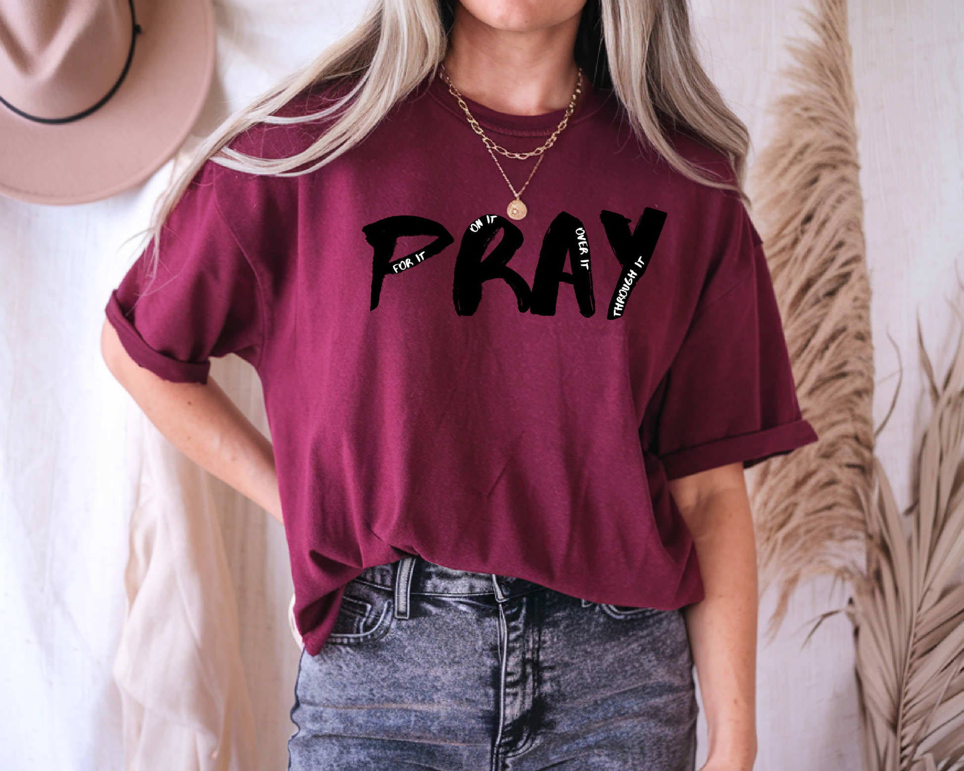 On the front of this custom handmade short sleeve shirt is the word pray in large black lettering, inside each letter in smaller writing are the words For it On it Over it and Through it in a different color font.