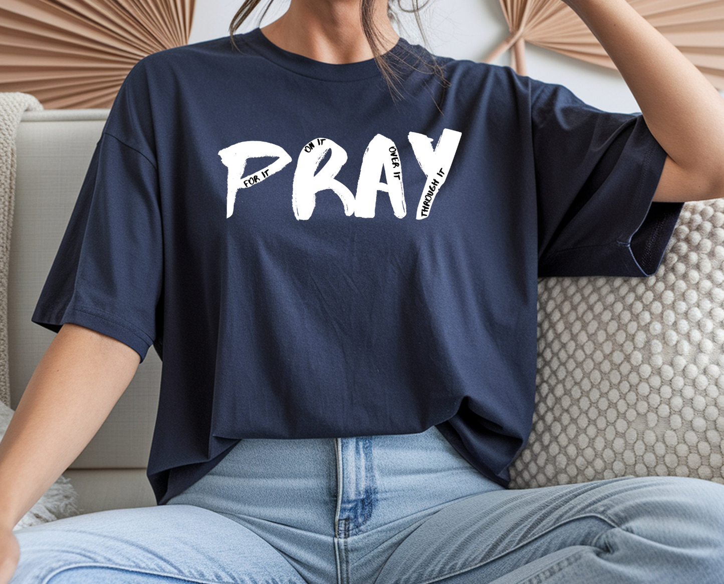 On the front of this custom handmade short sleeve shirt is the word pray in large black lettering, inside each letter in smaller writing are the words For it On it Over it and Through it in a different color font.