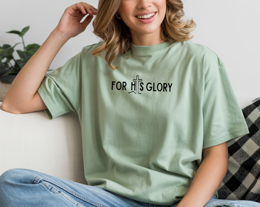 On the front of this super soft Christian unisex short sleeve shirt it says For His Glory with the letter I in the word His being a Jesus Cross.