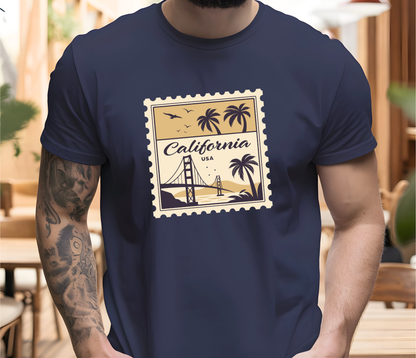 On the front of this custom vintage short sleeve shirt is a California postage stamp with images of the golden gate bridge, palm trees and the ocean on it, the entire stamp is different shades of beige.