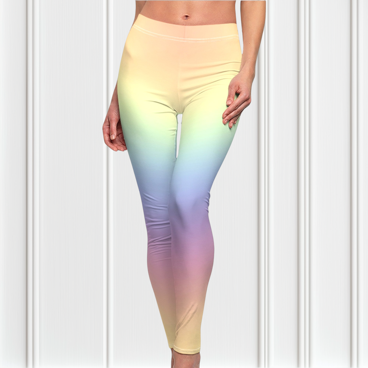 A pair of custom women's high waisted leggings with a soft gradient rainbow pattern all over the pants from top to bottom.