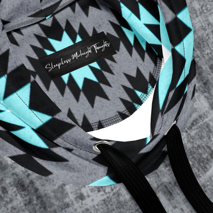 A custom unisex handmade hoodie with the front and the back of the hoodie being a washed grey pattern with the sleeves, hood and the front kangaroo pocket is a blue, black, grey and white Aztec western pattern that really pop next to the grey.