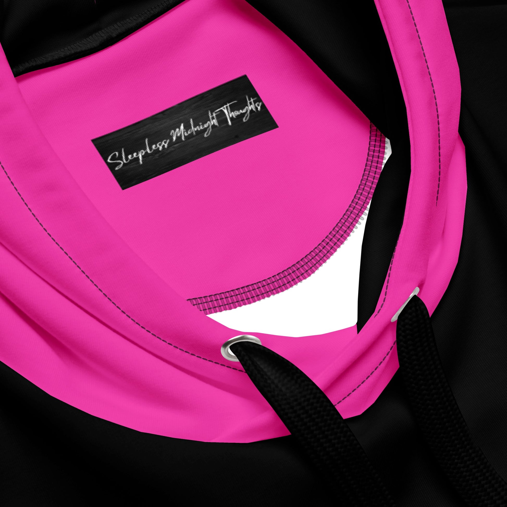 A women's custom oversized handmade hoodie, on the front and the back of the hoodie is the color black, the sleeves, front kangaroo pocket and hood are all a bright pink color, the strings of the sweater are black.