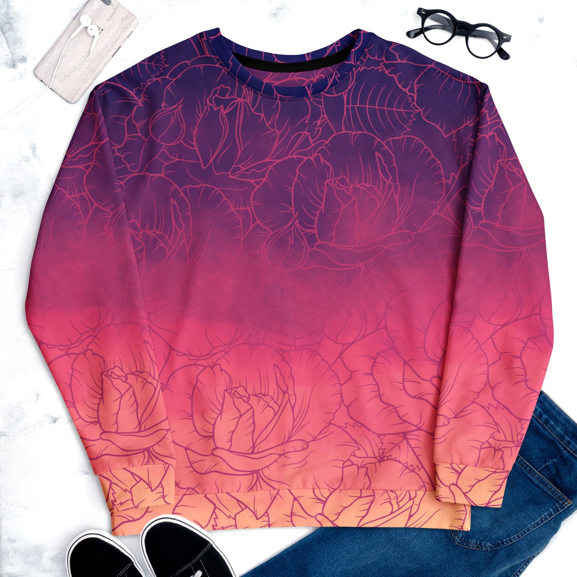 The sweater has a washed ombre pattern starting as a dark purple at the top of the neckline then fading to a light purple then to a bright pink then to a blush pink at the bottom, there is a purple floral pattern imposed on the top of the sweater.