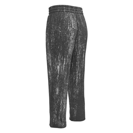 A pair of super soft unisex wide leg joggers that are mainly black all over with white lines running throughout the entire pair of pants making them look like they have been scratched up.