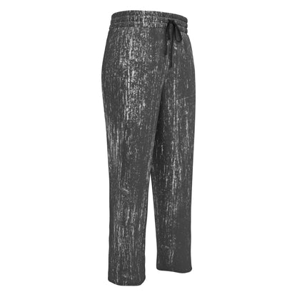 A pair of super soft unisex wide leg joggers that are mainly black all over with white lines running throughout the entire pair of pants making them look like they have been scratched up.