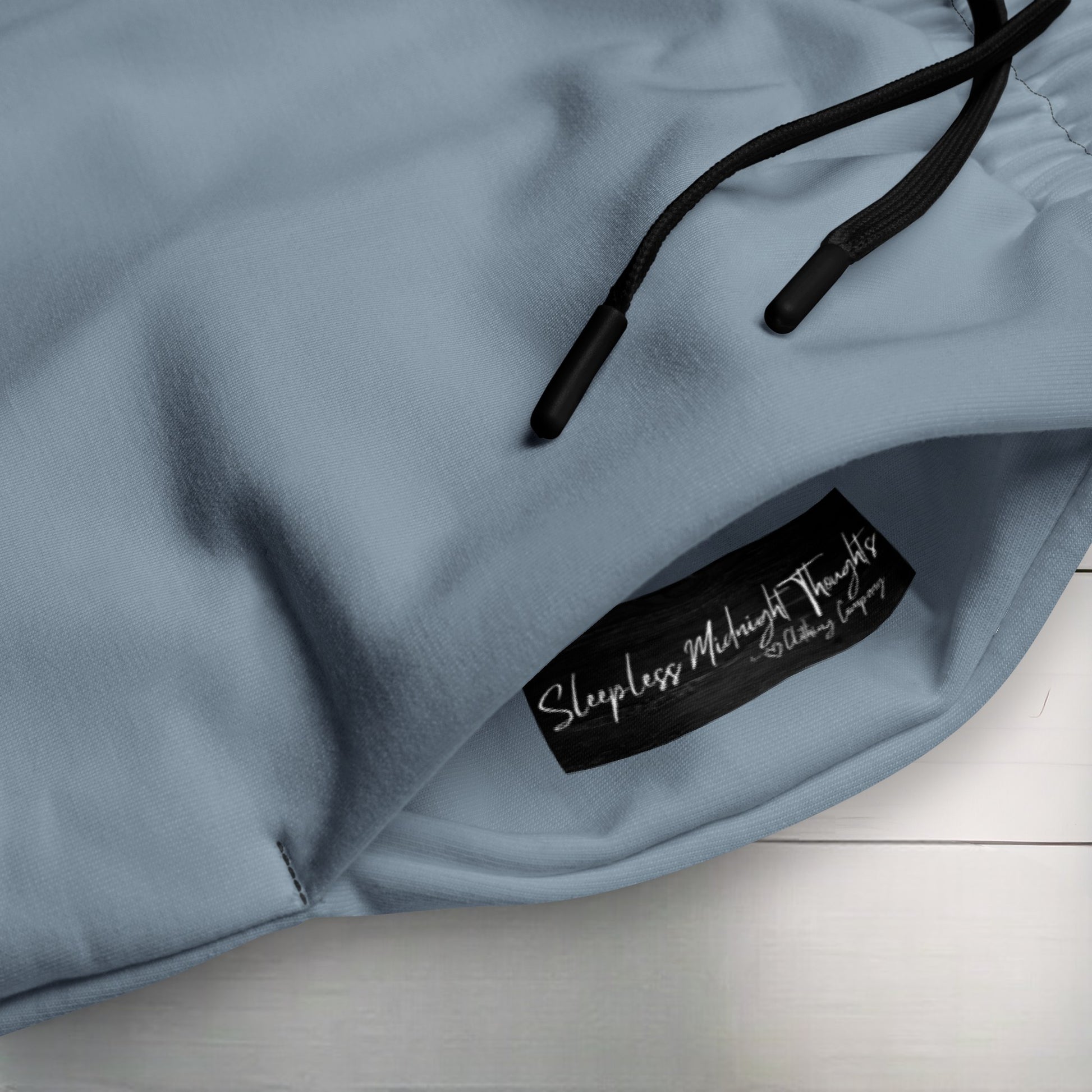 The entire pair of unisex wide leg joggers are a slate grey in color with the strings of the pants being black.