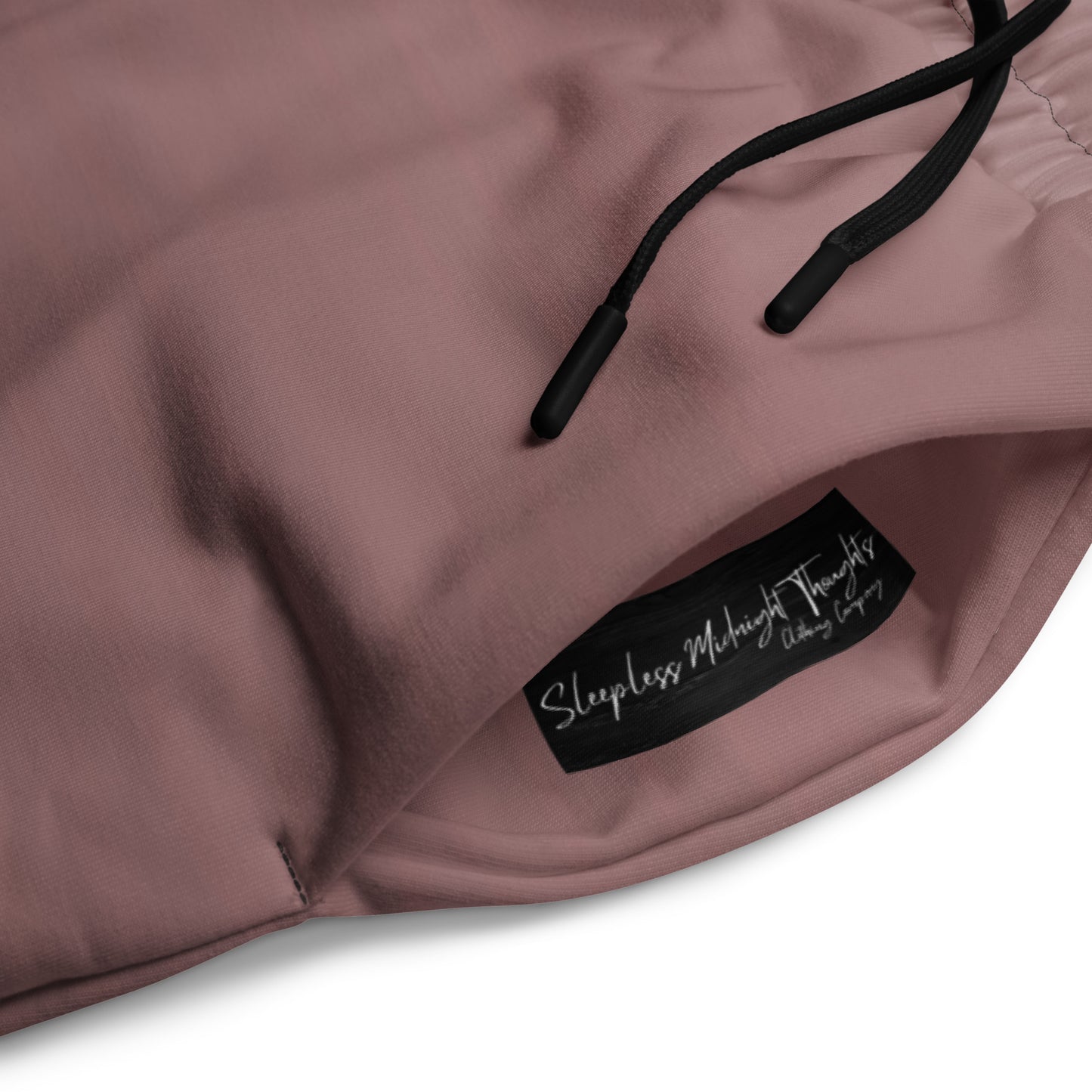 The super soft pair of wide leg unisex joggers that have a ombre pattern starting as a light mauve color on the top of the sweats and fading to a black color at the bottom of the sweats.