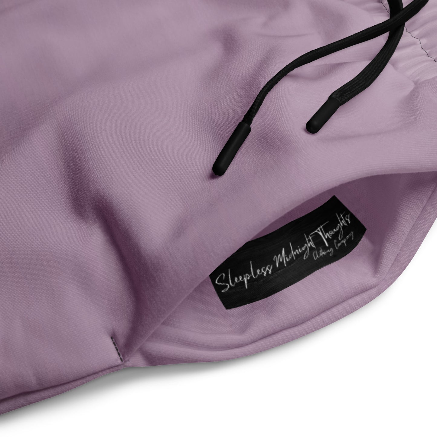 A pair of unisex wide leg joggers that have a ombre pattern starting with a lilac purple at the top then fading to a black at the bottom, the strings are black as well on this pair of pants.