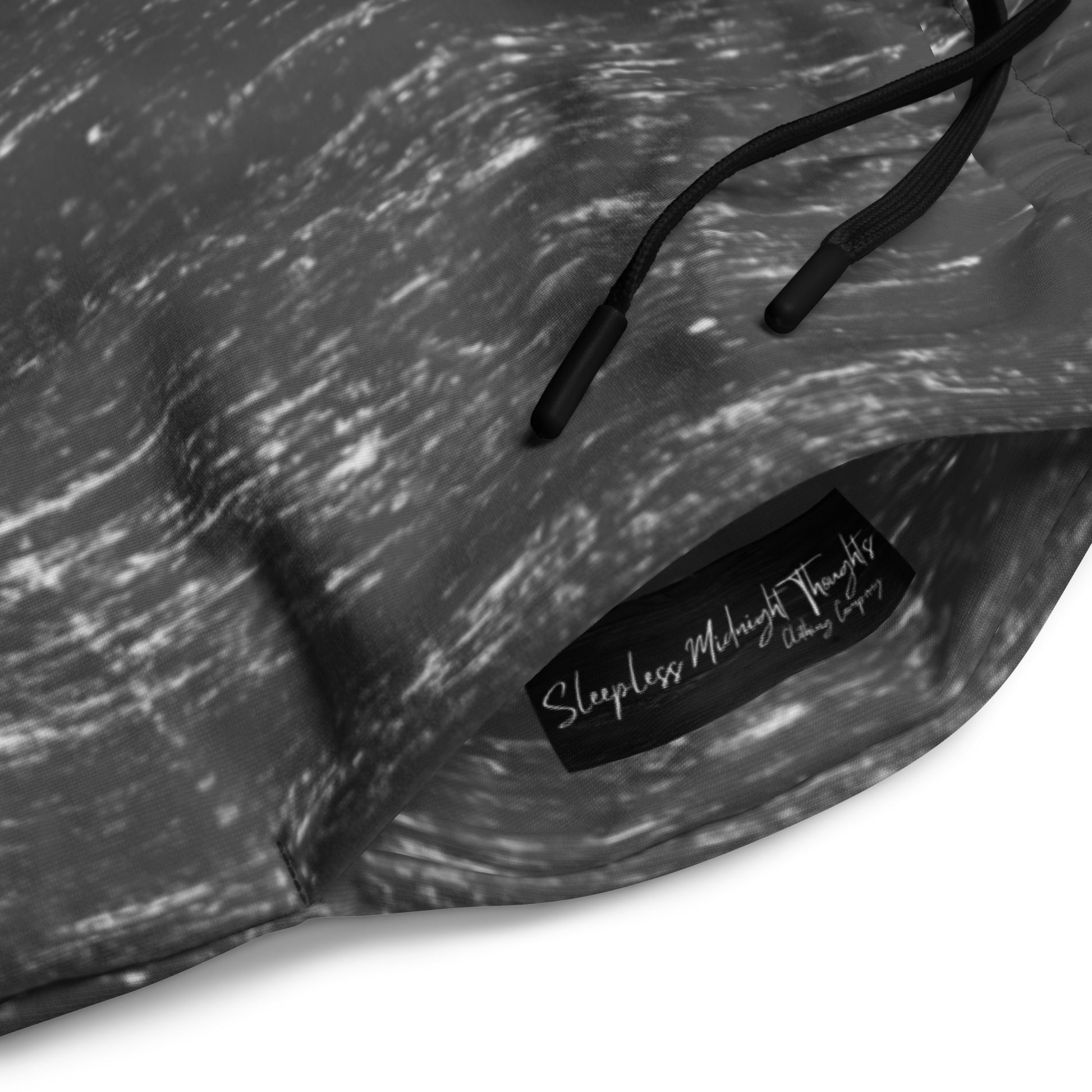 A pair of super soft unisex wide leg joggers that are mainly black all over with white lines running throughout the entire pair of pants making them look like they have been scratched up.