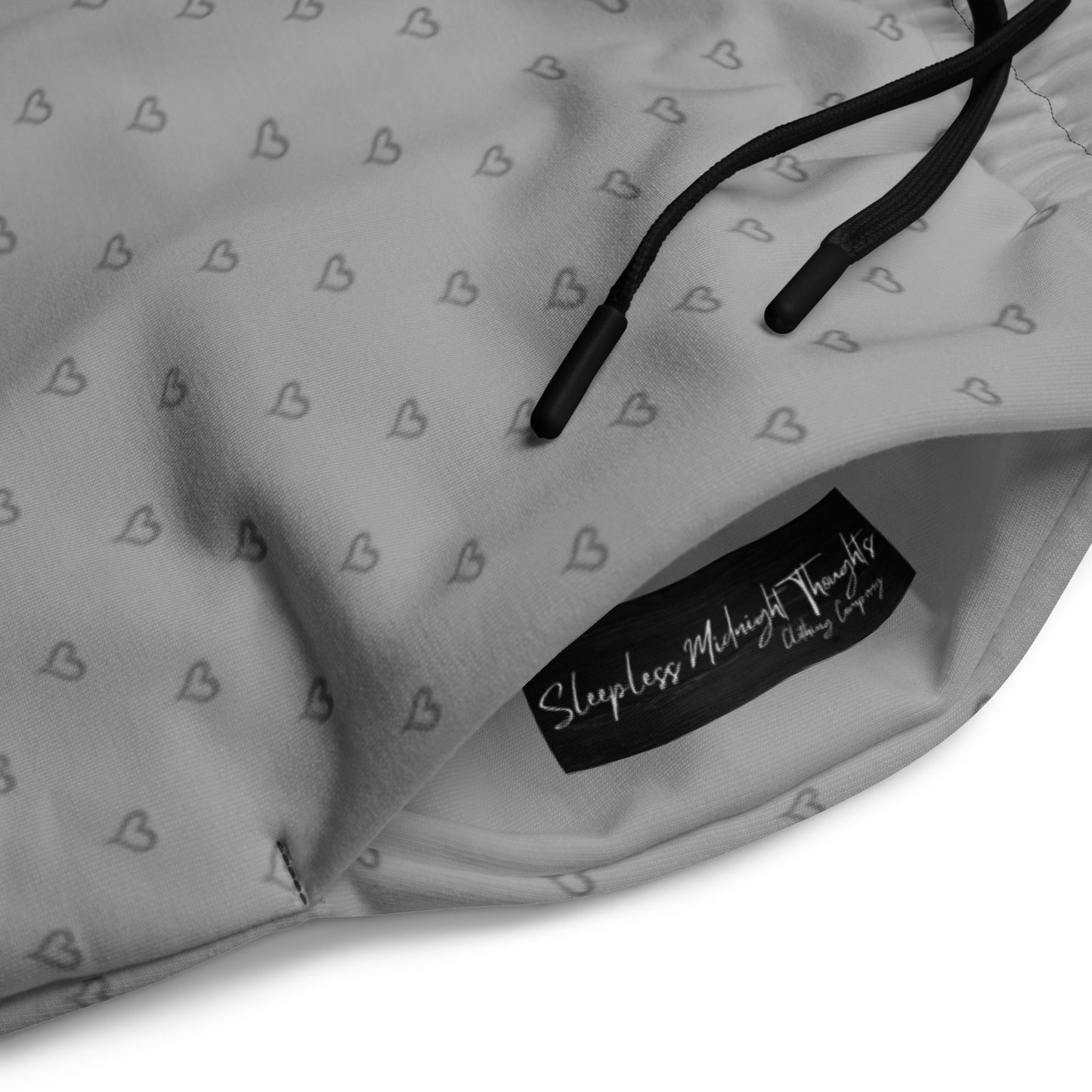 A pair of custom wide leg ombre sweatpants starting off as a light grey at the top then fading to a dark slate at the bottom, there is a dark slate grey heart pattern overlayed on the top that fades into the bottom of the sweatpants.