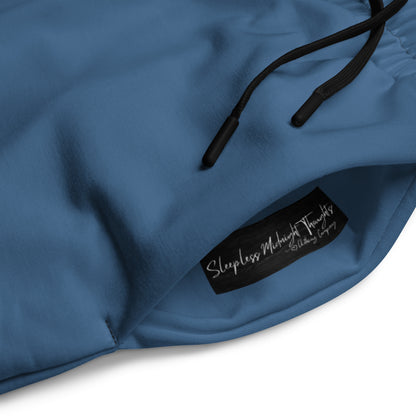 A pair of unisex wide leg joggers that are a ocean blue color from the top to the bottom with the strings of the sweats being black.