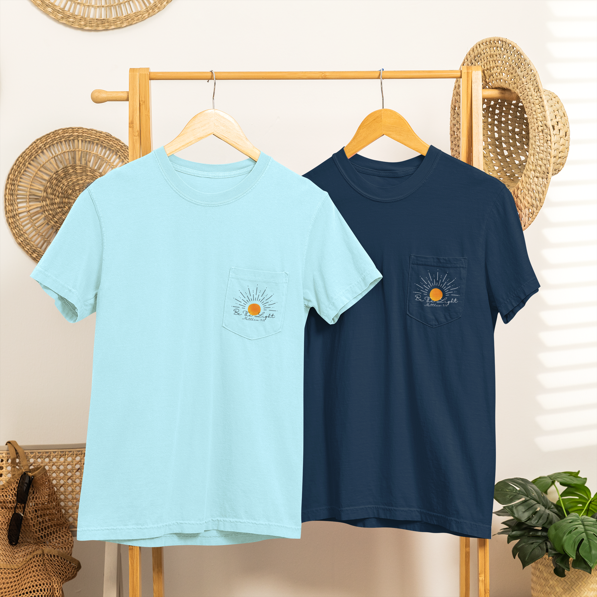 A custom Christian unisex pocket t-shirt, on the pocket that is over the left chest of the shirt is a large sun with the words Be The Light Matthew 5:14 of the Bible.